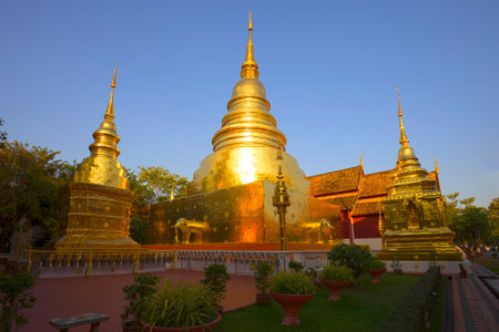 Golden chedi of the Buddhist temple Wat Phra Singh on a sunny evening. Chiag Mai, Thailandのeditorial素材