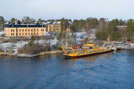 VAXHOLM, SWEDEN - MARCH 09, 2019: Car ferry at the city pier on a sunny March dayのeditorial素材