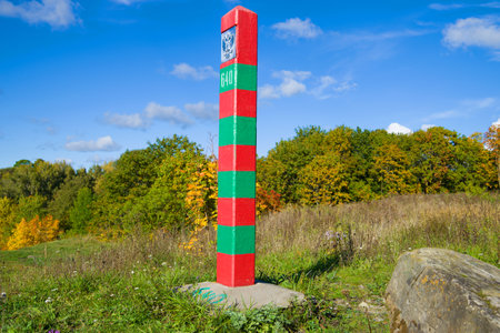 Russian border pillar in the autumn landscape on a sunny day.のeditorial素材