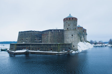 Olavinlinna fortress on a gloomy March day. Savonlinna, Finlandのeditorial素材