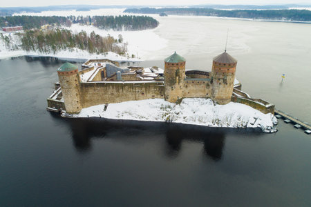 The ancient fortress of Savonlinna on the background of Saimaa lake on a cloudy March day (aerial photography). Finlandのeditorial素材