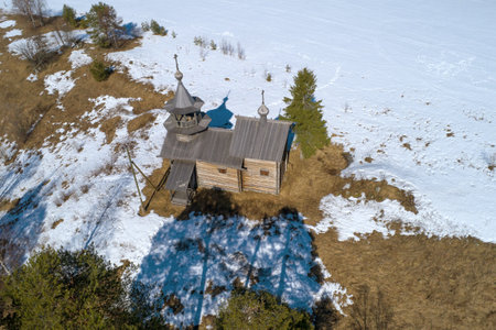 Ancient wooden chapel of the Nativity of the Virgin on a sunny April day (aerial photography). The village of Manga, Karelia. Russiaのeditorial素材