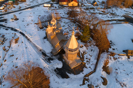 Aerial view of the ancient wooden church of Dmitry the Theunal Myrrh-stream in April evening (aerial photography). Village Shcheleyki, Leningrad Region, Russiaのeditorial素材