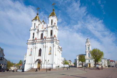 VITEBSK, BELARUS - MAY 02, 2019: Church of the Resurrection of Christ and the old town hall in the cityscape on a sunny May dayのeditorial素材