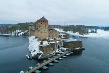 View of the ancient fortress of Olavinlinna on a March dusk day (shooting from a quadcopter) Savonlinna, Finlandのeditorial素材