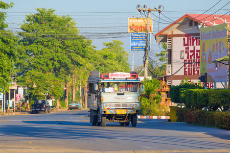 SUKHOTAI, THAILAND - DECEMBER 26, 2018: City bus on the basis of the old Hino truck in the city landscape on a sunny morningのeditorial素材