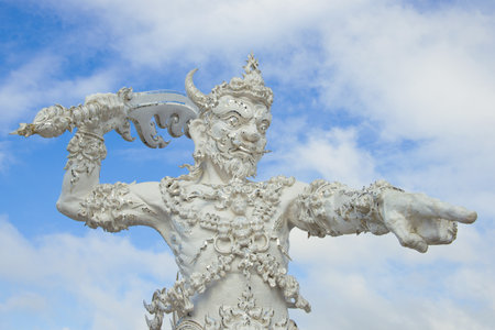CHIANG RAY, THAILAND - DECEMBER 16, 2018: Sculpture of a demon guarding the entrance to the Buddhist temple Wat Rong Khun (White Temple) close-upのeditorial素材