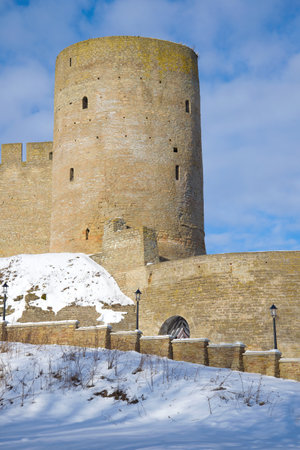 Long-necked tower close up on a sunny March day. A fragment of the Ivangorod fortress. Leningrad region, Russiaのeditorial素材