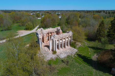 View of the ruins of the ancient Trinity Church in the village of Fifth Mountain on a sunny May day (shooting from a quadrocopter). Leningrad region, Russiaのeditorial素材