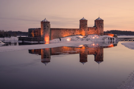 View of the ancient Olavinlinna fortress in March lilac twilight. Savonlinna, Finlandのeditorial素材