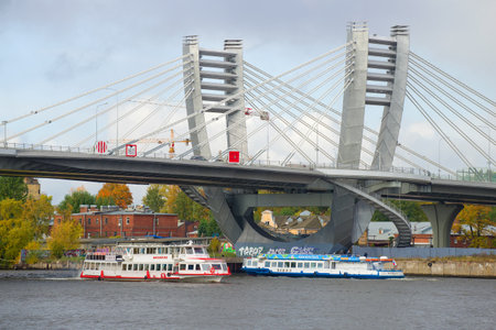ST. PETERSBURG, RUSSIA - OCTOBER 05, 2019: Two pleasure ships pass under the Betancourt bridge by...