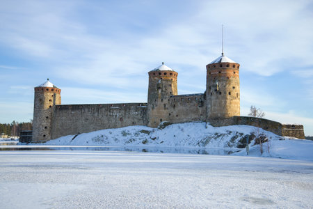 The ancient fortress of Olavinlinna on frozen Saimaa Lake on a winter day. Savonlinna, Finlandのeditorial素材