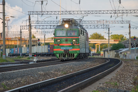 SHARYA, RUSSIA - JULY 03, 2019: Green VL80S electric locomotive with a freight train leaves from Sharya station of the Northern Railwayのeditorial素材