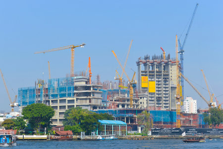 BANGKOK, THAILAND - DECEMBER 12, 2016: Construction of modern high-rise buildings on the banks of the Chao Phraya Riverのeditorial素材