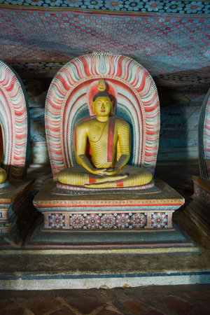 Ancient sculpture of a sitting Buddha in the cave Buddhist temple of Rangiri Dambulu Raja Maha Viharaya (Golden Temple). Dambulla, Sri Lankaのeditorial素材