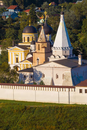 View of the temples of the Staritsky Holy Assumption Monastery on a warm August evening. Staritsa,...