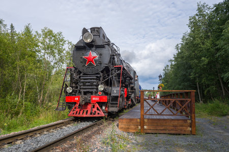 RUSKEALA, RUSSIA - AUGUST 15, 2020: Soviet steam locomotive LV-0522 and the Ruskealsky Express retro train at the apron of the Ruskeala Mountain Park stationのeditorial素材