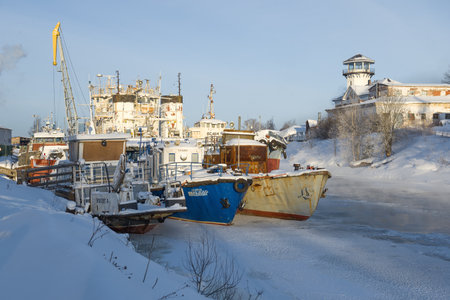 VYTEGRA, RUSSIA - FEBRUARY 23, 2021: Ships wintering in the river port of Vytegraのeditorial素材