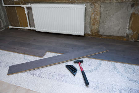 Laying laminate flooring in a small apartment roomの写真素材
