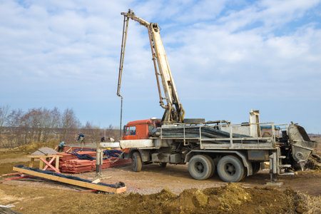 LENINGRAD REGION, RUSSIA - MARCH 28, 2021: A concrete pump based on a Kamaz truck on the construction site of a country house on a sunny spring dayのeditorial素材
