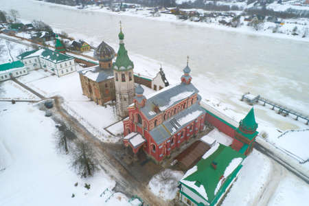 Over the ancient temples of the Old Ladoga Nikolsky Monastery on an overcast February day (filming from a quadcopter). Staraya Ladoga, Russiaの写真素材
