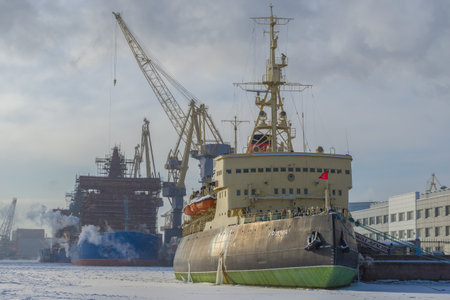 ST. PETERSBURG, RUSSIA - FEBRUARY 15, 2021: The old icebreaker Krasin against the backdrop of the Baltic Shipyard on a frosty February dayのeditorial素材