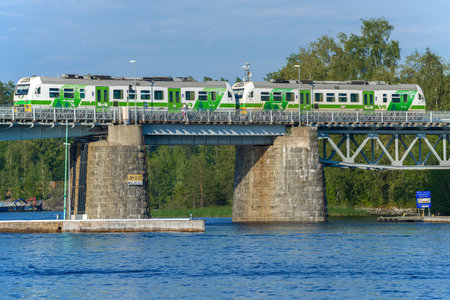SAVONLINNA, FINLAND - JULY 24, 2018: Suburban train on the railway bridge over the Kyurensalmi...