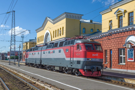 OREL, RUSSIA - JULY 06, 2021: Czech passenger electric locomotive ChS7 in front of the railway station building on a sunny July dayのeditorial素材