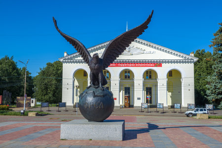 EAGLE, RUSSIA - JULY 06, 2021: Sculpture of a eagle on the globe against the background of the House of Culture of railway workers. Monument in honor of the 450th anniversary of the city of Orelのeditorial素材