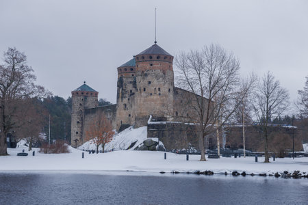 View of the ancient Olavinlinna fortress on a cloudy March day. Finland, Savonlinna