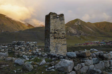 Ancient Ossetian defensive tower (Tsalikov Tower) on a September evening. The outskirts of the village of Dalagkau. North Ossetia, Russiaの写真素材