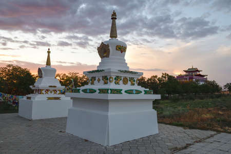Stupas at the Syakyusn-syume Buddhist temple against the backdrop of a September cloudy sunset. Environs of Elista. Republic of Kalmykia, Russian Federationの写真素材