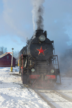SORTAVALA, RUSSIA - MARCH 10, 2021: Cargo mainline Soviet steam locomotive LV-0522 close-up on a...