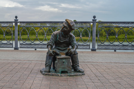 ASTRAKHAN, RUSSIA - SEPTEMBER 22, 2021: Urban sculpture "Shoe Shine" on Petrovskaya Embankment on a cloudy September dayのeditorial素材