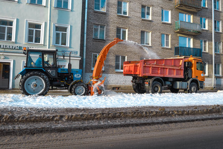 KRONSTADT, RUSSIA - JANUARY 18, 2022: Snow removal by communal equipment on the sidewalk