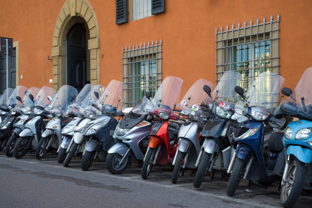 FLORENCE, ITALY - SEPTEMBER 19, 2018: Parked motor scooters against the background of a old residential buildingのeditorial素材