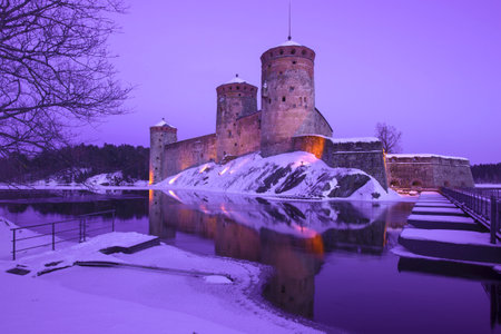 Ancient fortress Olavinlinna (Olafsborg) in lilac March twilight. Savonlinna, Finlandのeditorial素材