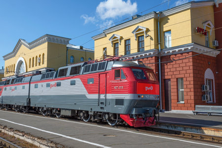 ORYOL, RUSSIA - JULY 06, 2021: Czech passenger electric locomotive ChS7-015 against the background of the railway station building on a sunny summer dayのeditorial素材