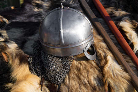 A helmet of norman-type (viking's helmet, reconstruction) lies on the animal's skinの写真素材