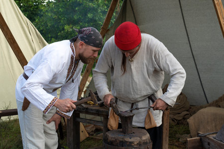 TVER REGION, RUSSIA - JULY 22, 2022: Teaching the basics of blacksmithing on the historical festival of "Epic Coast - 2022"のeditorial素材