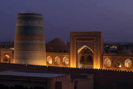 KHIVA, UZBEKISTAN - SEPTEMBER 06, 2022: Evening over Kalta Minor minaret and Muhammad Amin Khan madrasahのeditorial素材