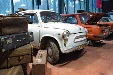 ZELENOGORSK, RUSSIA - JANUARY 27, 2021: Old Zaporozhets ZAZ-965 peeks out from behind a pile of old suitcases. Museum of retro cars "Horsepower"のeditorial素材