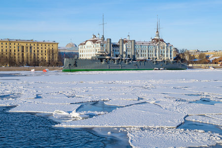 ST. PETERSBURG, RUSSIA - FEBRUARY 12, 2023: Cruiser "Aurora" against the background of the building of the Nakhimov Naval School on a sunny February dayのeditorial素材
