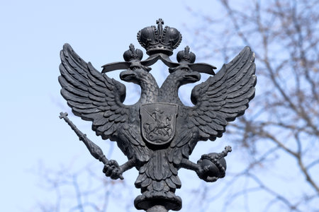 KRONSTADT, RUSSIA - MARCH 13, 2023: The old skullpture of the two-headed eagle is the coat of arms of the Russian Empire. Fragment of the design of the gate of the Summer Gardenのeditorial素材
