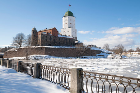 View of the ancient Vyborg castle from the side of the city embankment on a sunny March. Leningrad region, Russiaのeditorial素材