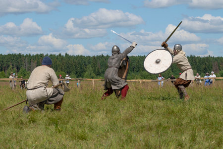 TVER REGION, RUSSIA - JULY 22, 2022: Medieval swordsmen duel on a sunny July day. Historical festival "Epic Coast-2022"のeditorial素材