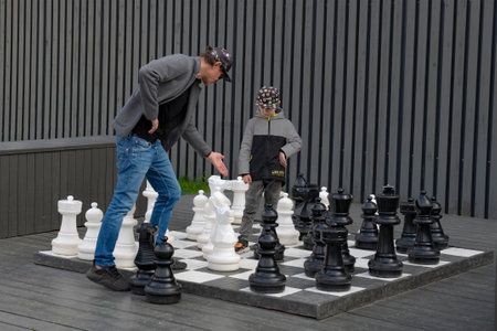 SAINT PETERSBURG, RUSSIA - MAY 14, 2023: Father and son play floor chess on the territory of the...
