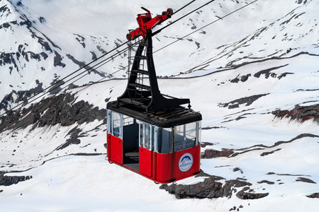 ELBRUS, RUSSIA - JUNE 08, 2023: Empty cabin of the old cable car against the backdrop of eternal snows. Elbrus Mountainのeditorial素材
