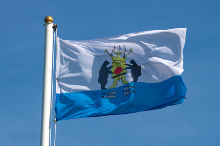 The flag with the modern coat of arms of Veliky Novgorod is close-up on a sunny day. Russiaの写真素材