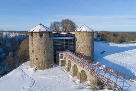 View of the towers and bridge of the ancient Koporskaya fortress on a sunny February day. Leningrad...